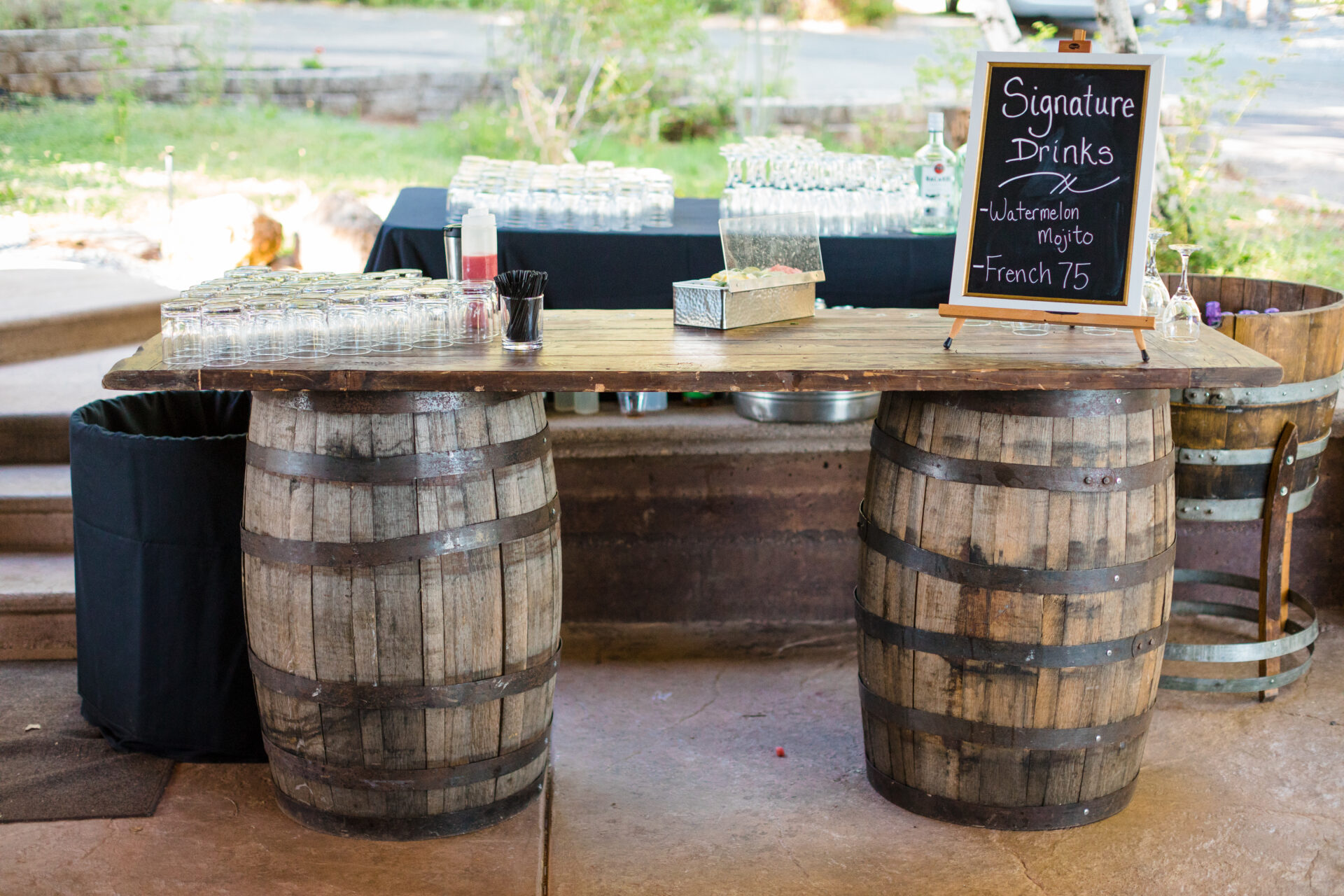 A bar made out of wine barrels at a mountain wedding.